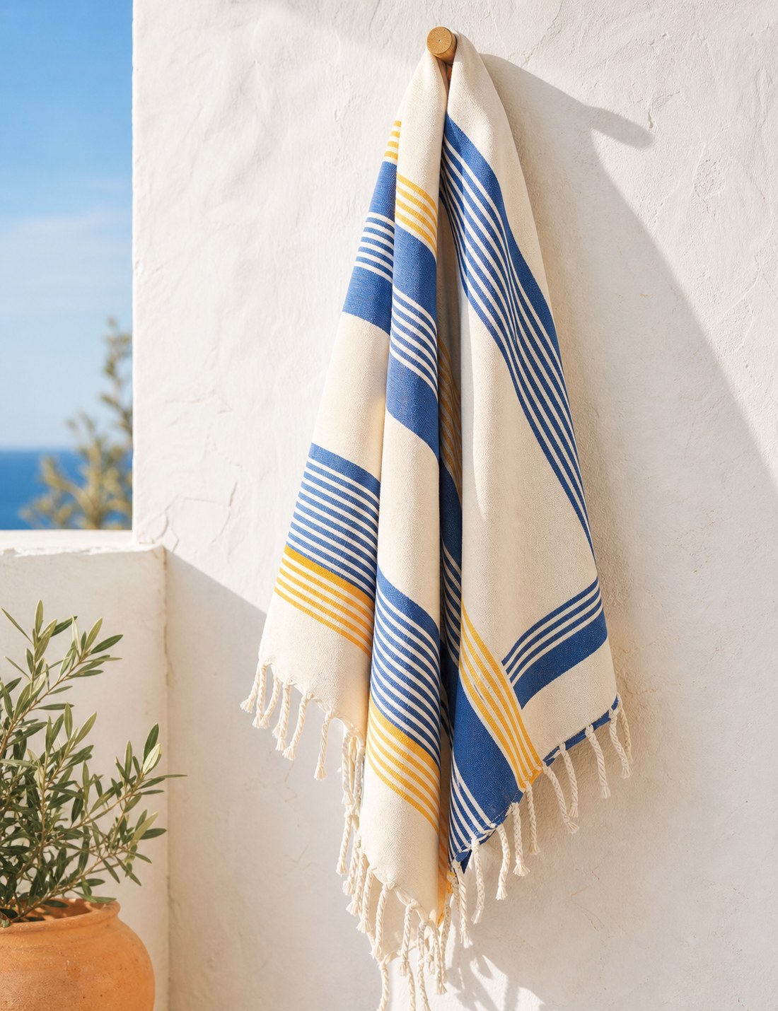 Striped pestemal hanging on a hook, fringe in view